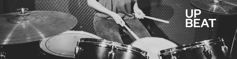 Drummer performing advanced Samba techniques on stage, playing on a drum set