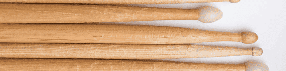 A collection of drumsticks neatly organized on a table, ready for selection by a drummer.