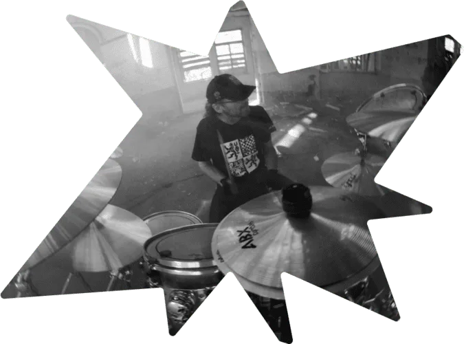 Drummer in a fun and lively practice session on his drum set.