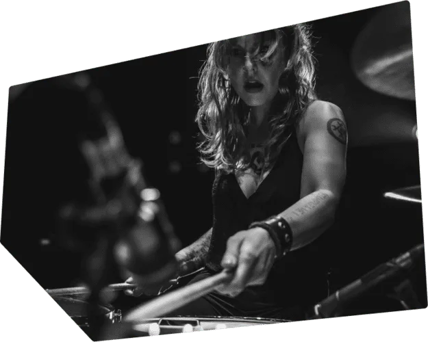 Drummer having fun while practicing on his drum set.